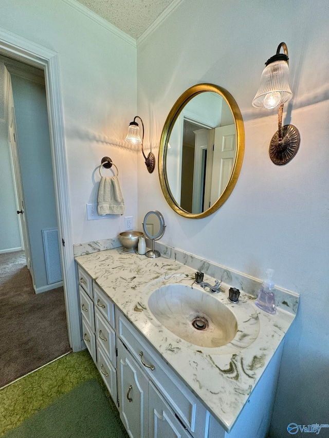 bathroom with ornamental molding and vanity