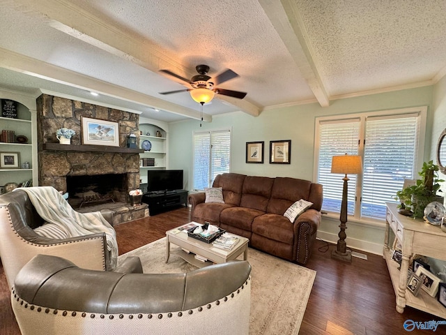 living room with a wealth of natural light, ceiling fan, dark hardwood / wood-style flooring, and a textured ceiling