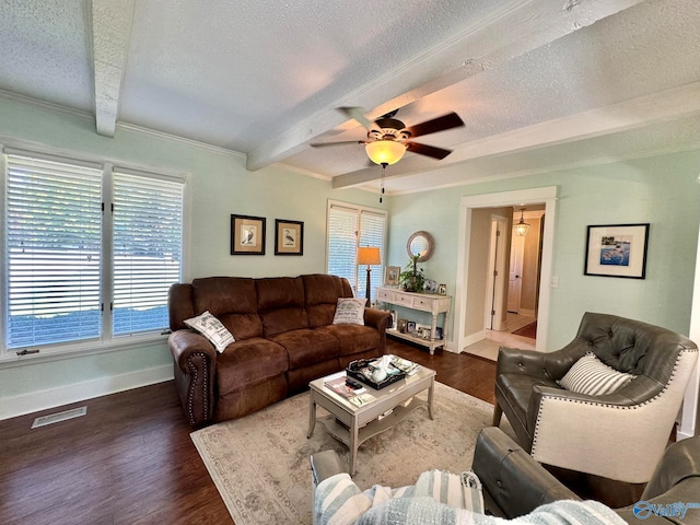 living room featuring a wealth of natural light, ceiling fan, hardwood / wood-style flooring, and beam ceiling