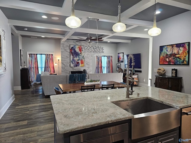 kitchen with dark hardwood / wood-style floors, decorative light fixtures, beamed ceiling, coffered ceiling, and light stone counters