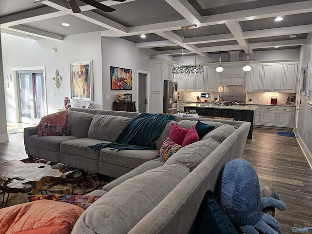 living room with coffered ceiling, beam ceiling, dark hardwood / wood-style floors, and ceiling fan