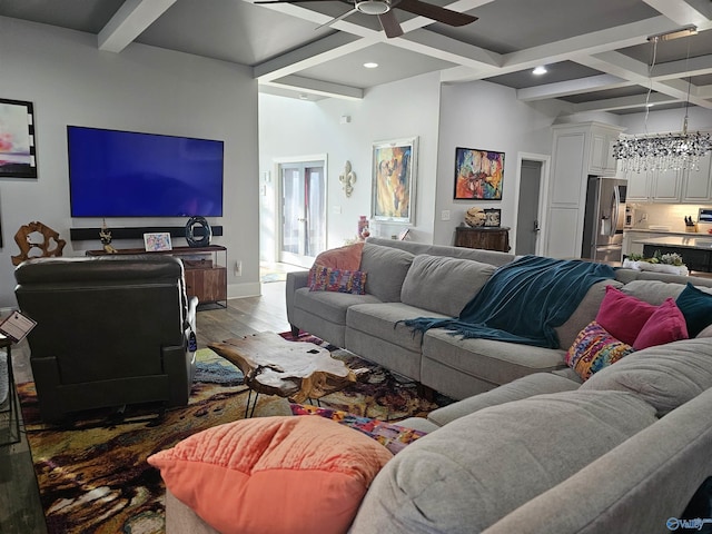 living room with hardwood / wood-style flooring, ceiling fan, coffered ceiling, and beamed ceiling