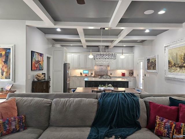 living room with coffered ceiling, beam ceiling, and sink