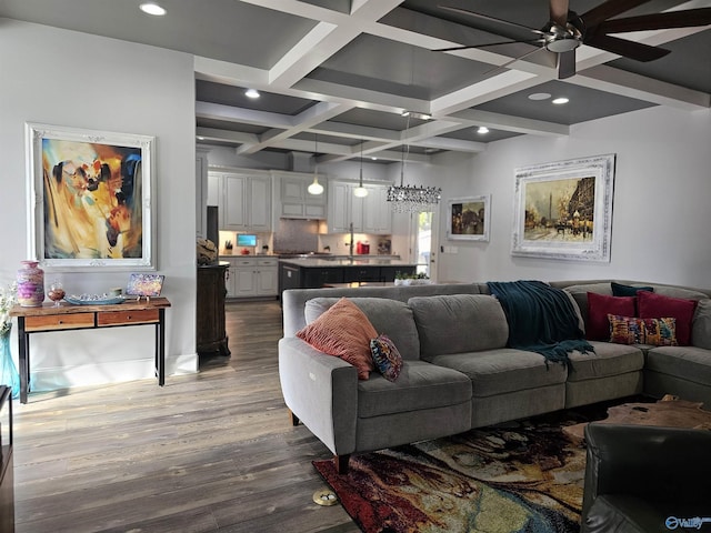 living room featuring beam ceiling, ceiling fan, coffered ceiling, and dark hardwood / wood-style floors