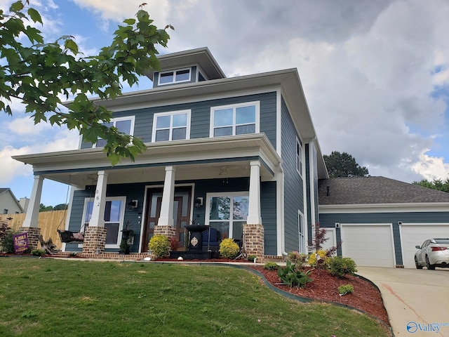 view of front of home featuring a porch, a garage, and a front lawn