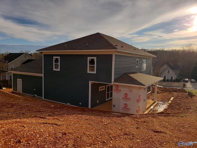 view of back house at dusk