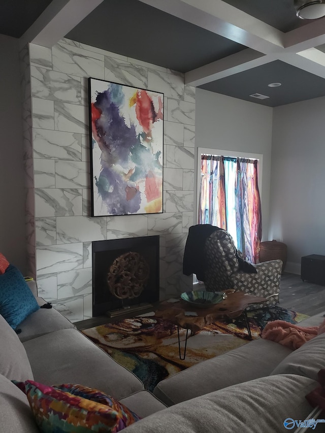 living room featuring beamed ceiling, coffered ceiling, and tile walls