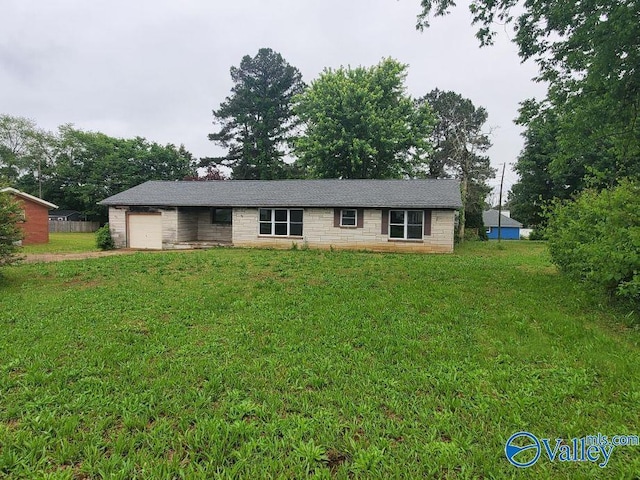32 Hannah Dr, Rogersville, AL 35652 - ranch-style house with an attached garage, driveway, a front yard, and stone siding