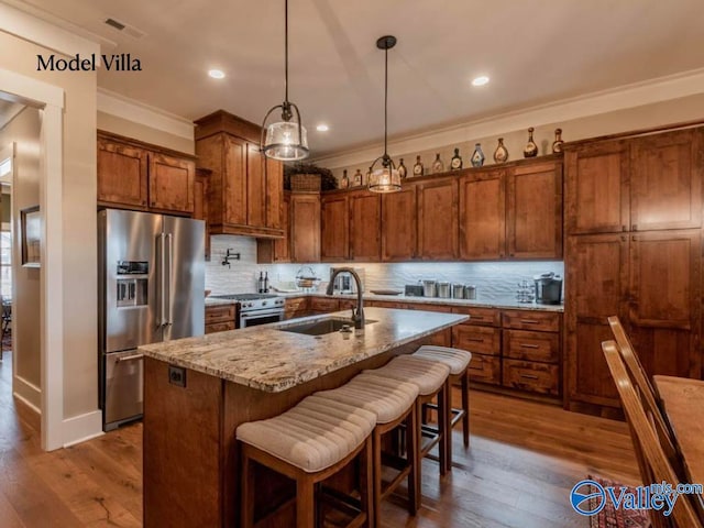 kitchen with wood-type flooring, decorative backsplash, and high end appliances