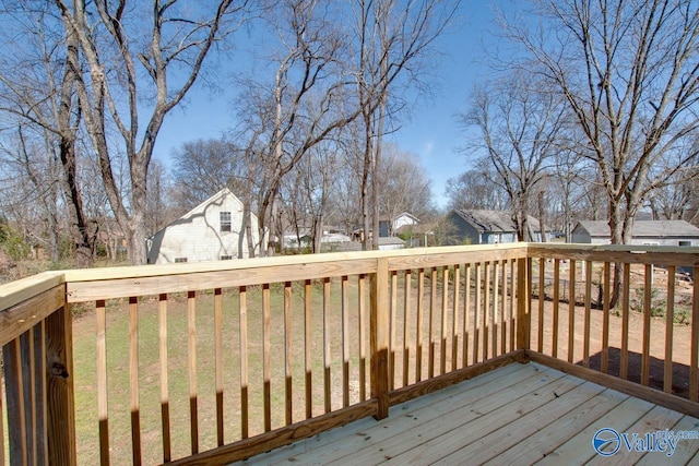 wooden terrace featuring a residential view and a yard