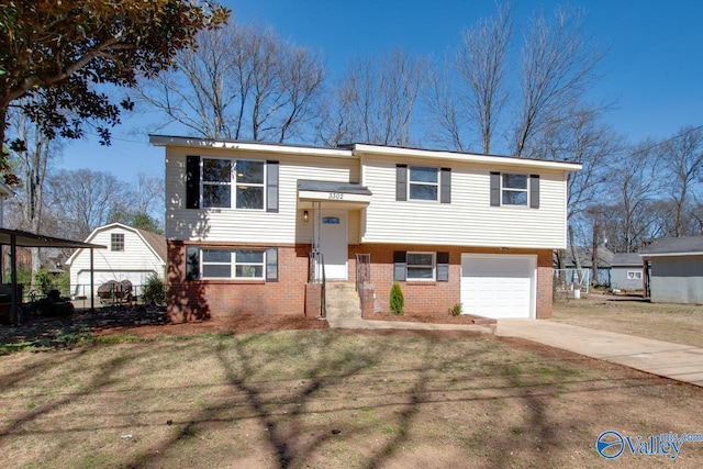 raised ranch with fence, concrete driveway, a front yard, a garage, and brick siding