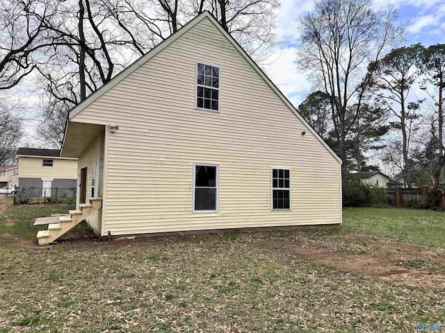 view of property exterior featuring a yard and fence