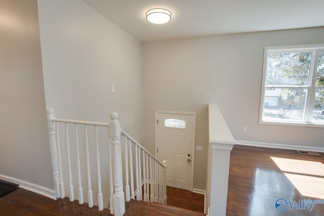 interior space featuring visible vents, baseboards, and wood finished floors