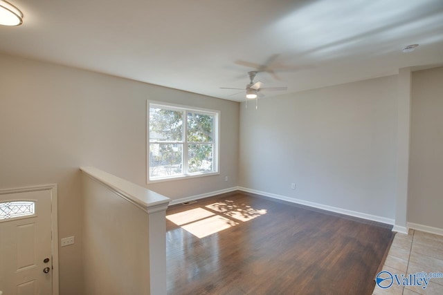 unfurnished room featuring visible vents, a ceiling fan, baseboards, and wood finished floors