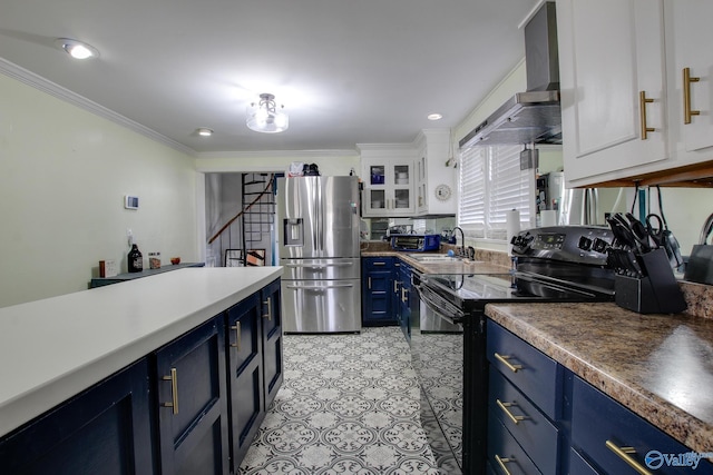 kitchen with wall chimney range hood, stainless steel fridge, white cabinetry, blue cabinets, and black / electric stove