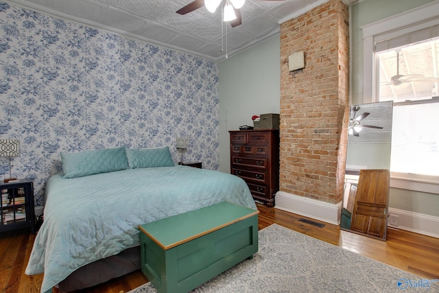bedroom featuring hardwood / wood-style floors and ceiling fan
