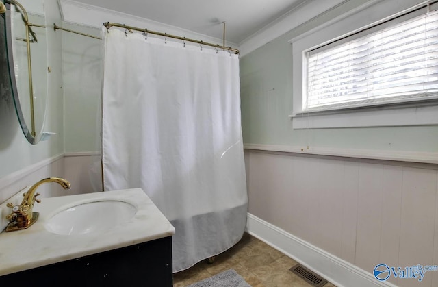 bathroom featuring ornamental molding and vanity
