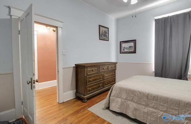 bedroom with crown molding and light hardwood / wood-style flooring