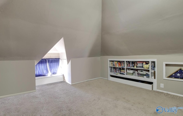 bonus room featuring vaulted ceiling and light colored carpet