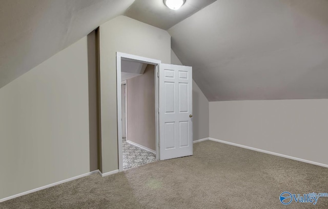 bonus room featuring vaulted ceiling and carpet flooring