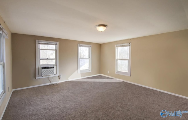unfurnished room with cooling unit and carpet flooring