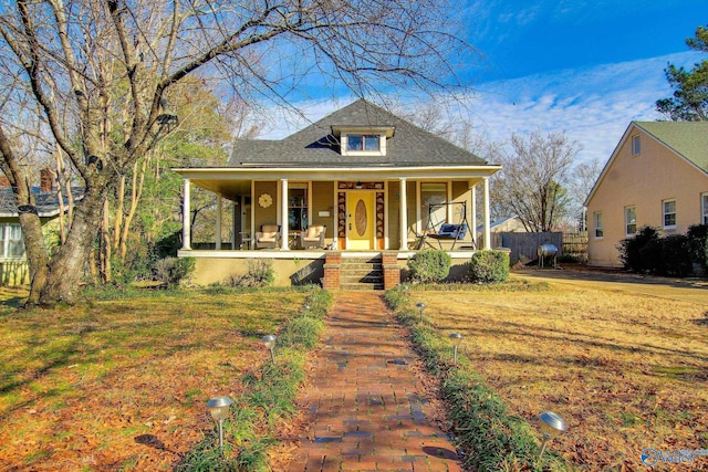 bungalow-style house with covered porch and a front yard