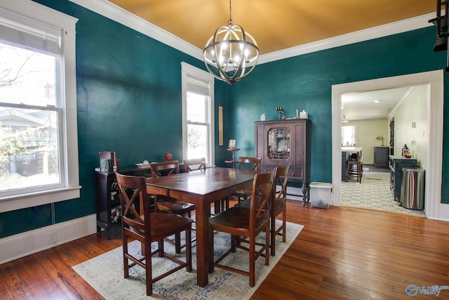 dining room featuring ornamental molding, dark hardwood / wood-style flooring, and a chandelier