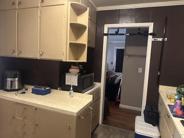 220 E Walnut St, Gadsden, AL 35903 - kitchen with black microwave, open shelves, light countertops, crown molding, and dark wood-style floors