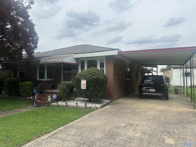 220 E Walnut St, Gadsden, AL 35903 - view of front of property featuring driveway, brick siding, a carport, and a shingled roof