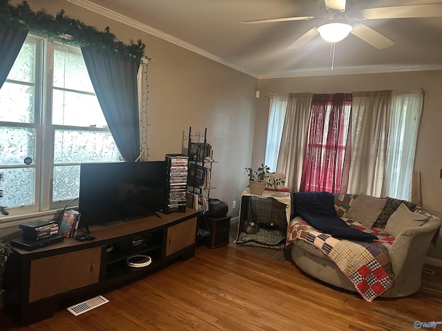 220 E Walnut St, Gadsden, AL 35903 - living area featuring wood finished floors, ornamental molding, healthy amount of natural light, a desk, and a ceiling fan