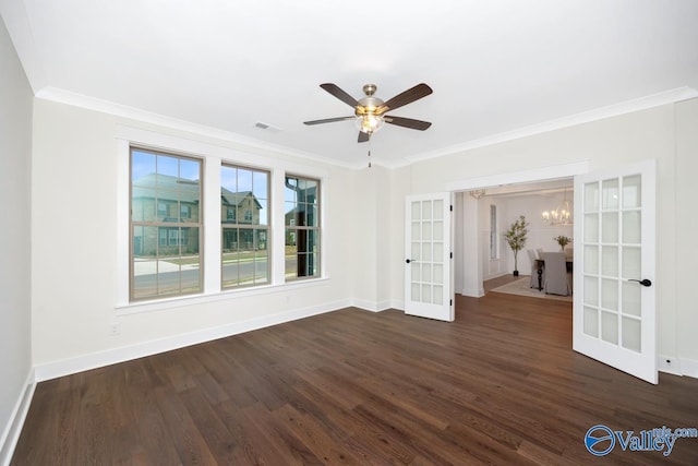 spare room featuring french doors, ornamental molding, dark wood finished floors, and baseboards