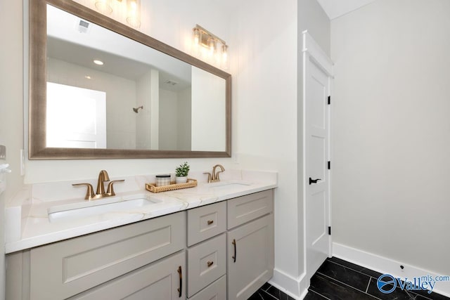 full bathroom featuring double vanity, tile patterned floors, and baseboards