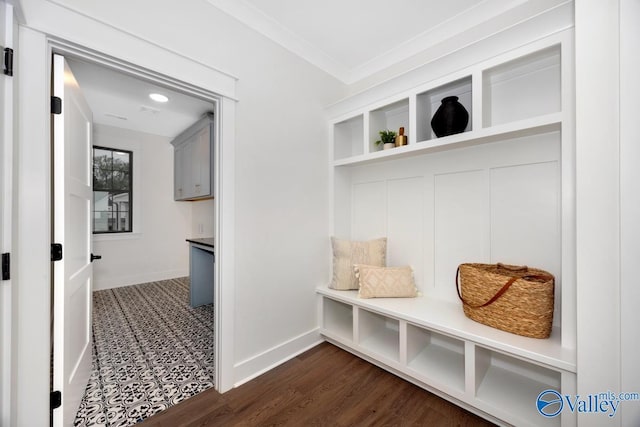 mudroom featuring baseboards, dark wood-type flooring, and crown molding