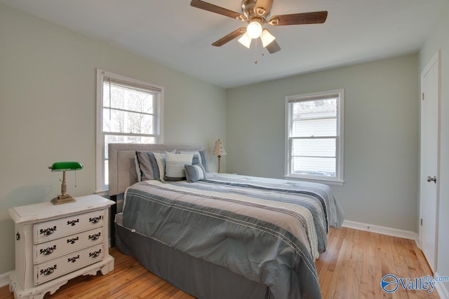 1608 Humes Ave, Huntsville, AL 35801 - bedroom with baseboards, multiple windows, and light wood-style flooring