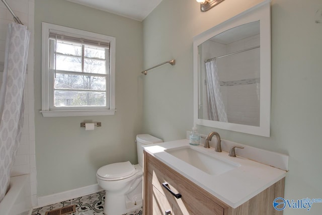 1608 Humes Ave, Huntsville, AL 35801 - full bathroom with tile patterned flooring, vanity, toilet, shower / bathtub combination with curtain, and baseboards