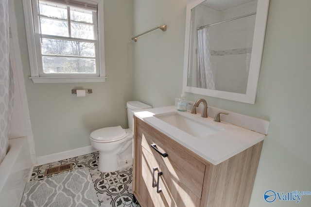 1608 Humes Ave, Huntsville, AL 35801 - full bath with vanity, baseboards, tile patterned flooring, and toilet