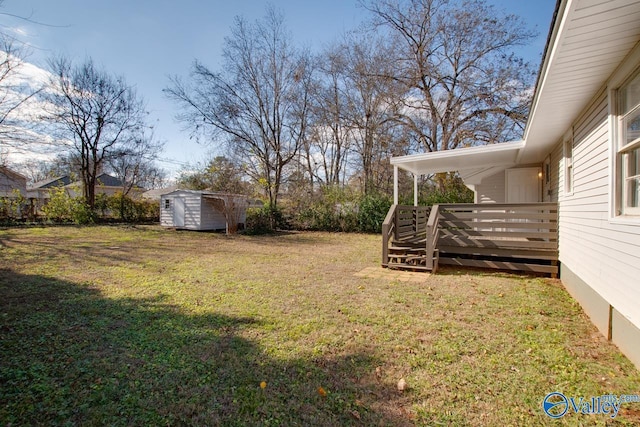 1608 Humes Ave, Huntsville, AL 35801 - view of yard featuring a storage unit, a wooden deck, and an outbuilding