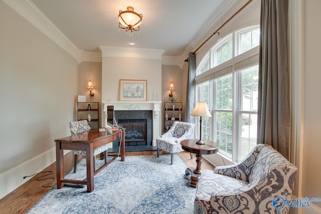 living area featuring hardwood / wood-style flooring and crown molding