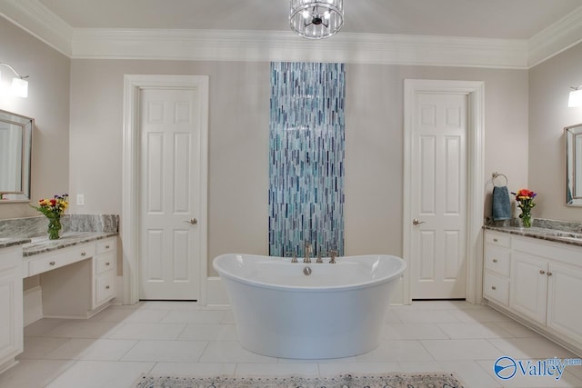 bathroom featuring a washtub, vanity, tile patterned floors, and ornamental molding