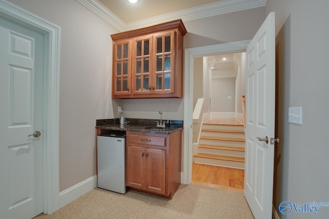 bar with light carpet, fridge, crown molding, and sink