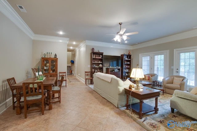 tiled living room with ornamental molding, ceiling fan, and french doors