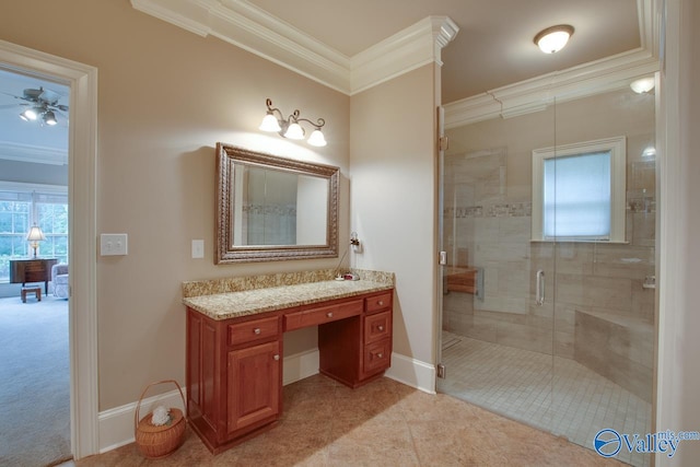 bathroom featuring tile patterned flooring, a shower with door, vanity, ceiling fan, and ornamental molding