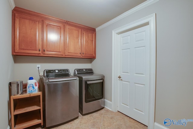 washroom with separate washer and dryer, ornamental molding, cabinets, and light tile patterned flooring