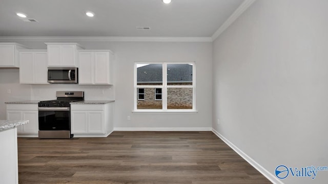 22392 Westminster Dr, Athens, AL 35613 - kitchen featuring stainless steel appliances, crown molding, white cabinetry, light stone countertops, and dark wood finished floors