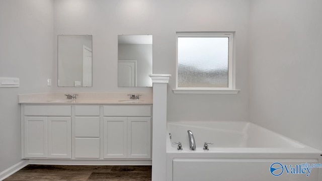22392 Westminster Dr, Athens, AL 35613 - bathroom featuring double vanity, a bath, and wood finished floors