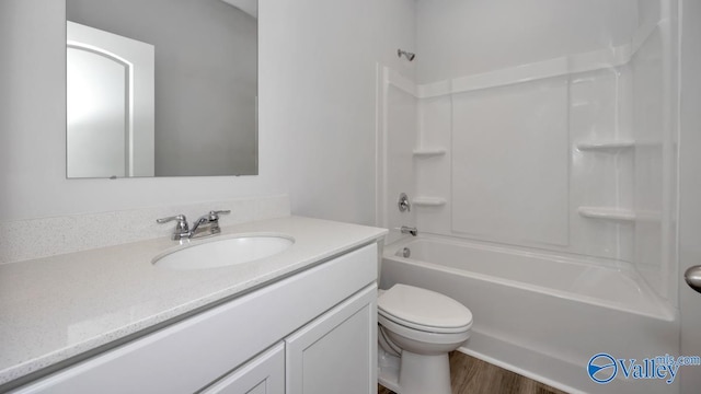 22392 Westminster Dr, Athens, AL 35613 - full bathroom featuring vanity, toilet,  shower combination, and wood finished floors