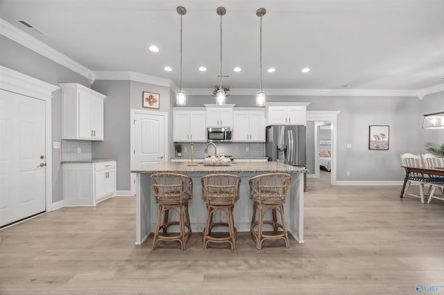 17067 Stonegate Dr, Athens, AL 35613 - kitchen with white cabinets, stainless steel appliances, visible vents, backsplash, and crown molding