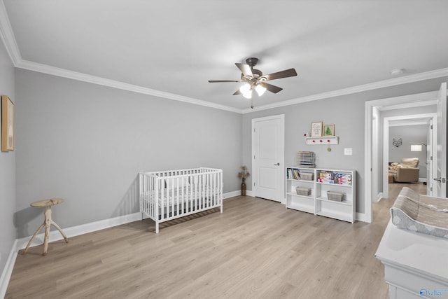 17067 Stonegate Dr, Athens, AL 35613 - bedroom with light wood finished floors, baseboards, ornamental molding, and a crib