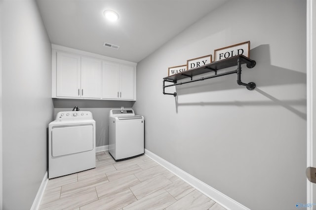 17067 Stonegate Dr, Athens, AL 35613 - laundry room with cabinet space, visible vents, baseboards, and washer and clothes dryer