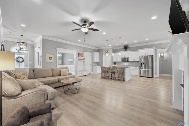 17067 Stonegate Dr, Athens, AL 35613 - living area with light wood-type flooring, baseboards, recessed lighting, ceiling fan, and ornamental molding